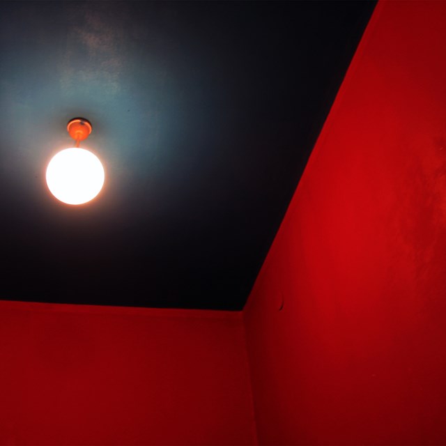 Living room Photography by MARTA LESNIAKOWSKA titled Red room NR 42. TRIBUTE TO WILLIAM EGGLESTON
